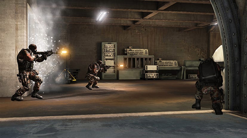 A screenshot of America's Army: Proving Grounds. It shows three soldiers firing down a hallway.