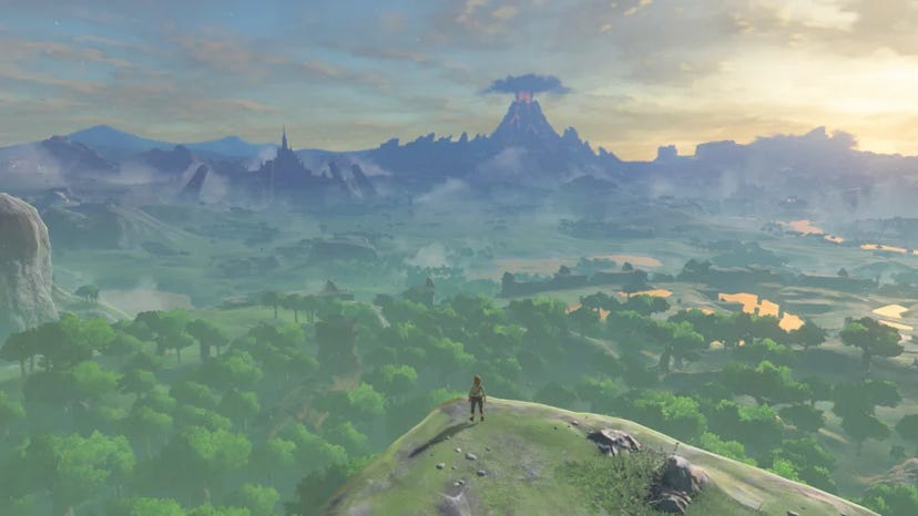 A screenshot from Breath of the Wild depicting Link overlooking Hyrule from a high cliff.