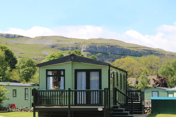 A caravan with countryside in the background Littondale Country & Leisure Park in Yorkshire