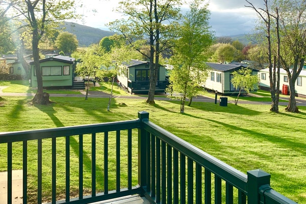 A view of caravans and countryside from decking at Littondale Country & Leisure Park in Yorkshire