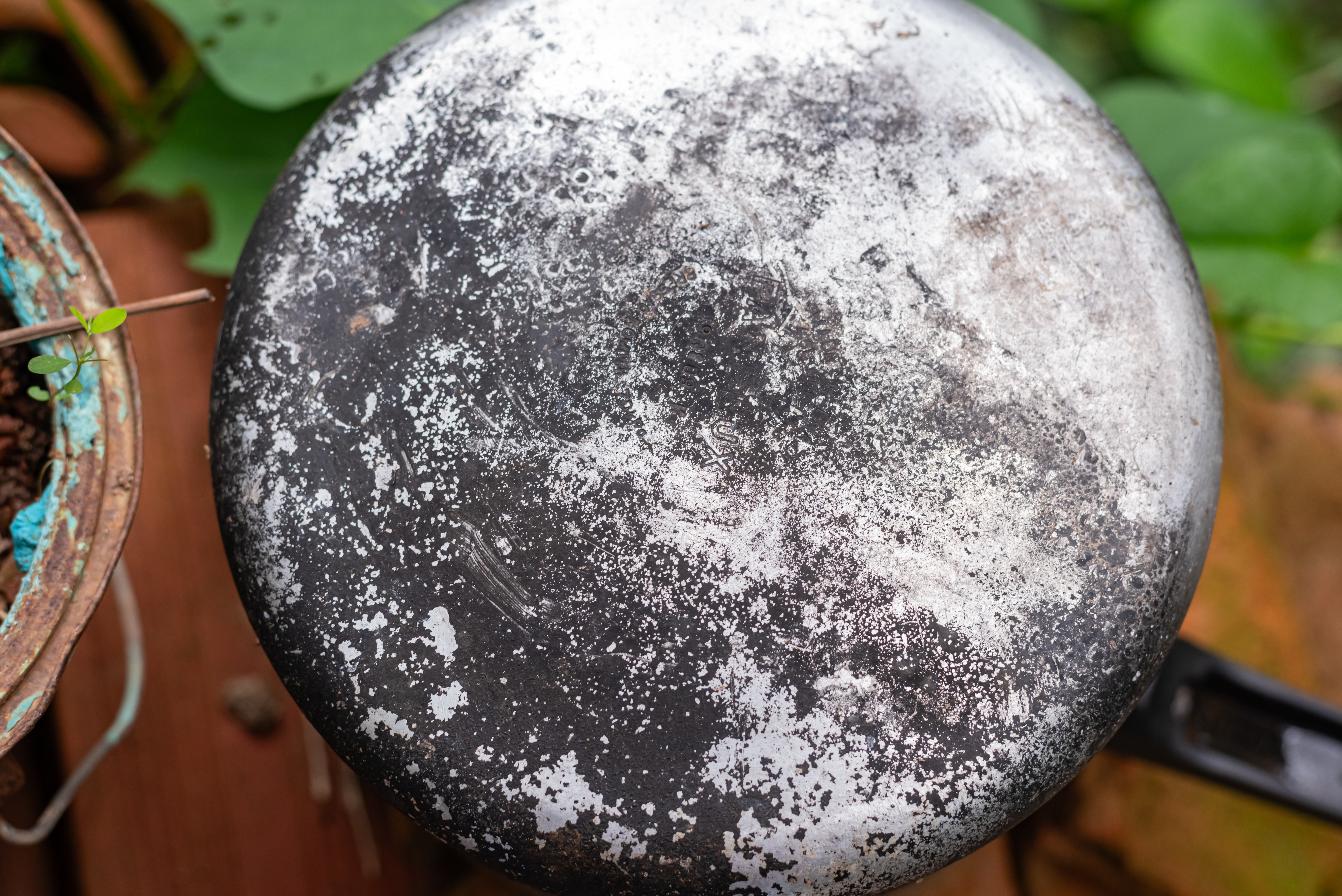 Bottom of a burnt and worn cooking pot