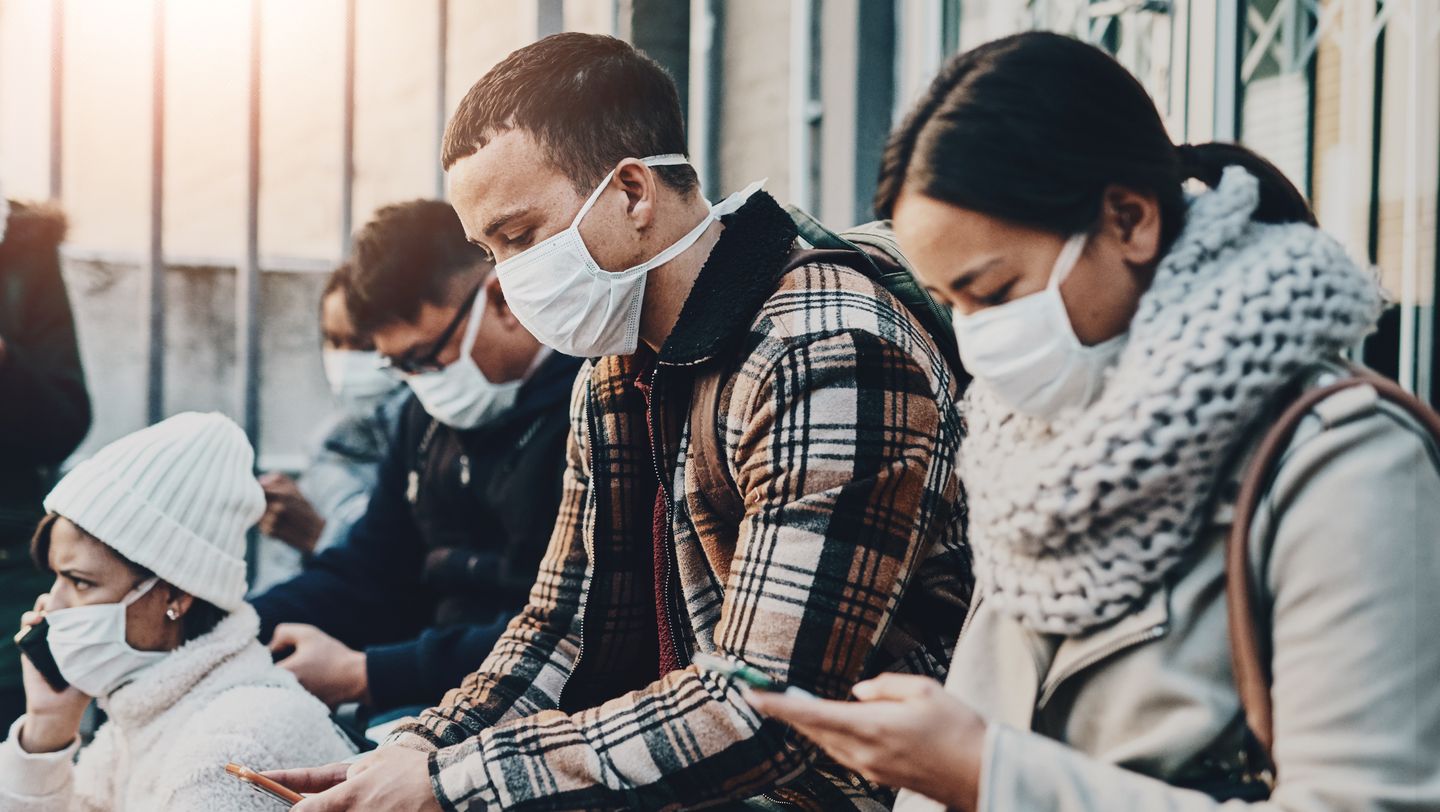 Group of people sitting with face masks on