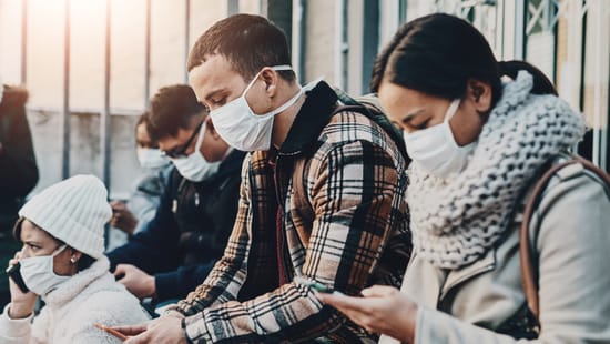 Group of people sitting with face masks on