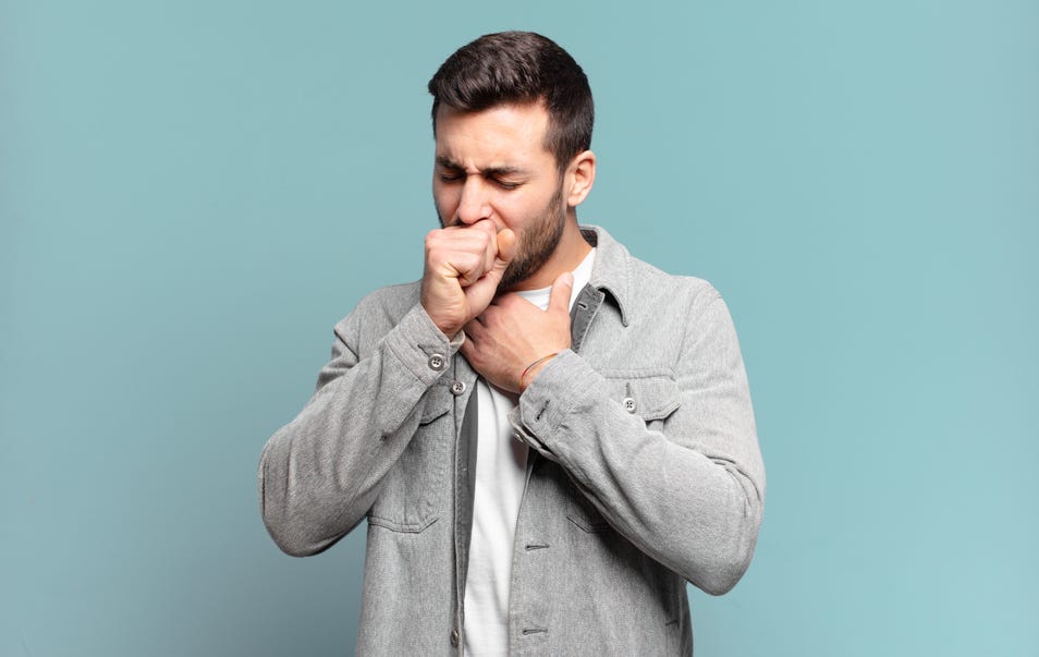 A man holding his throat while coughing at the same time