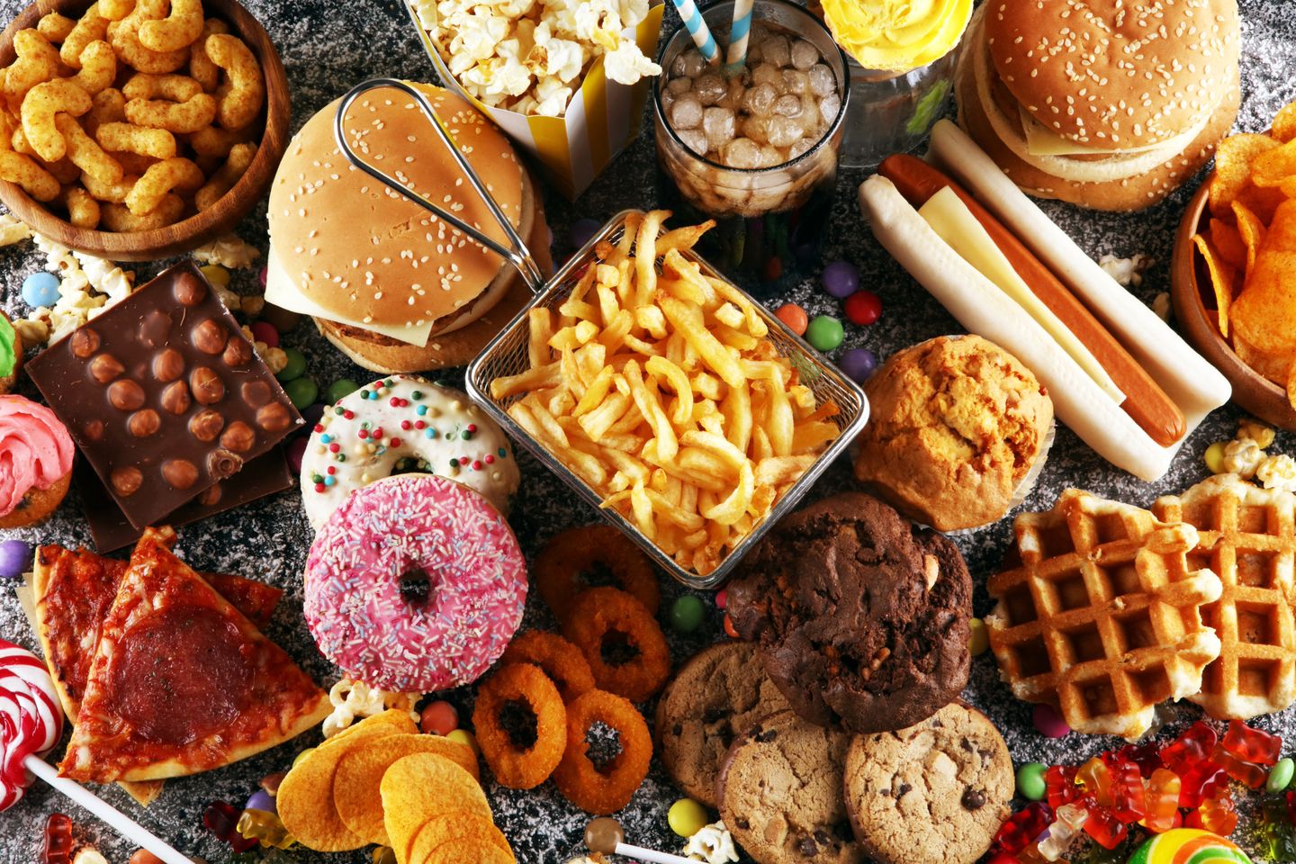 Top shot of fast food items like burgers, fries, and snacks