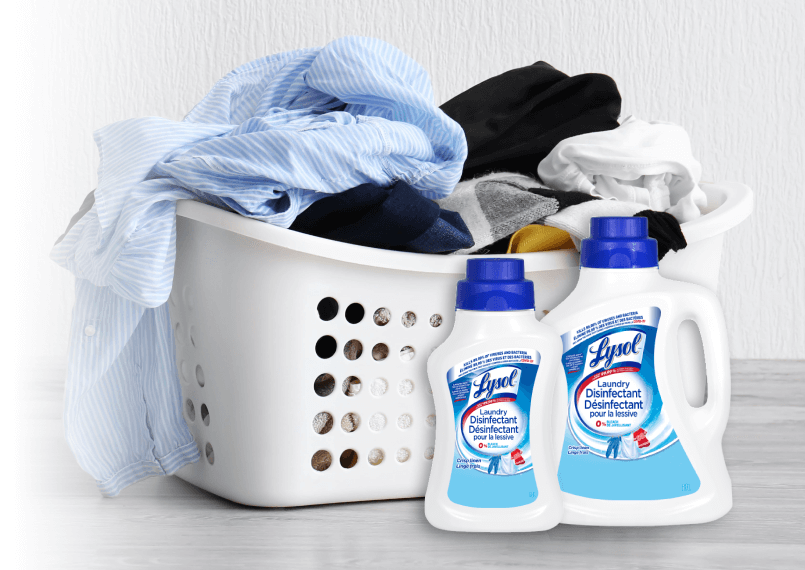 Laundry basket filled with clothes alongside Lysol Laundry Disinfectant - Crisp Linen