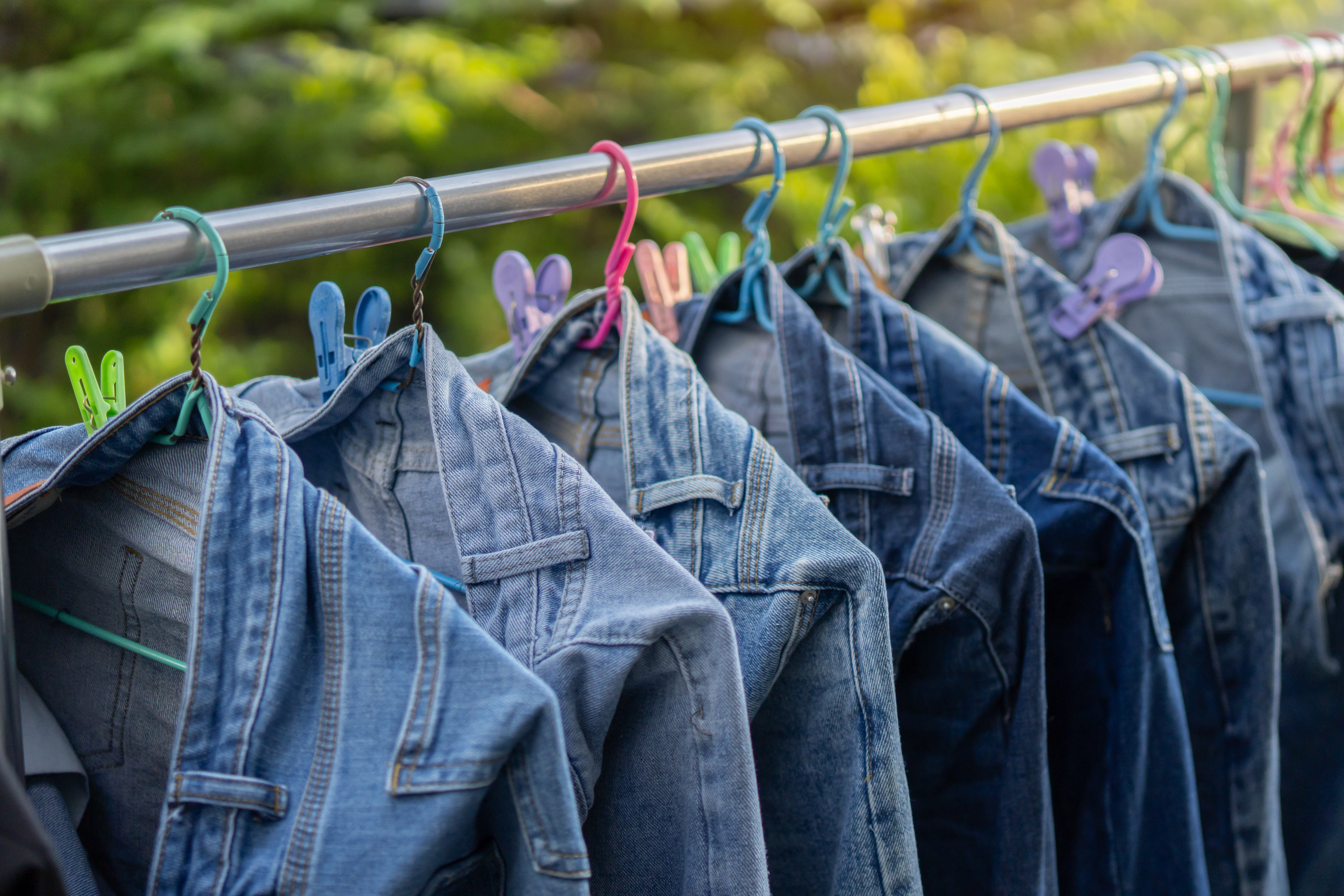 Jeans hanging on hangers to dry