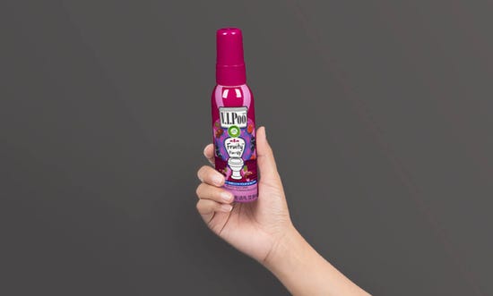 V.I.Poo™ Fruity Pin-Up™ 55ml being held up in a hand.