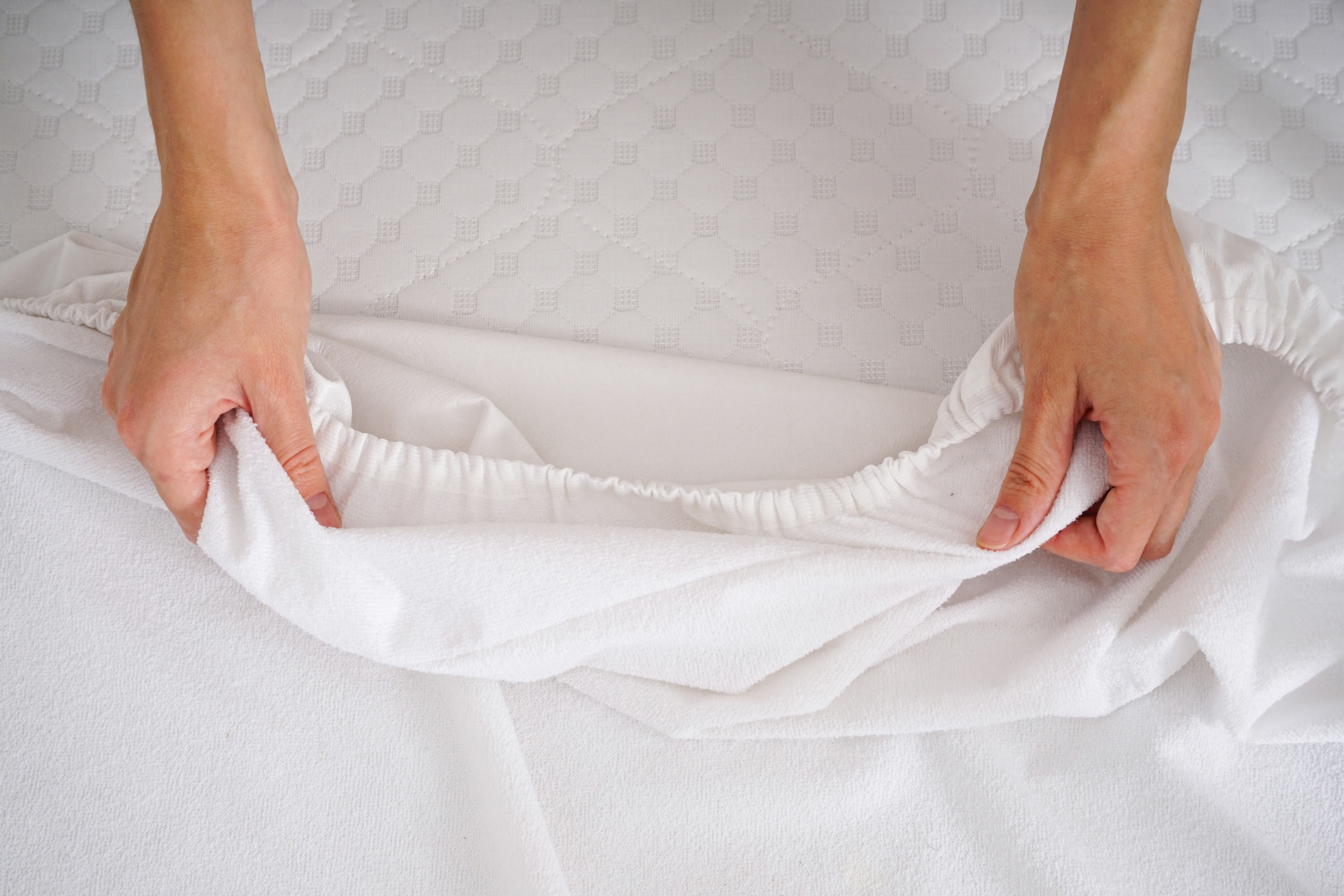 A person holding clean white sheets