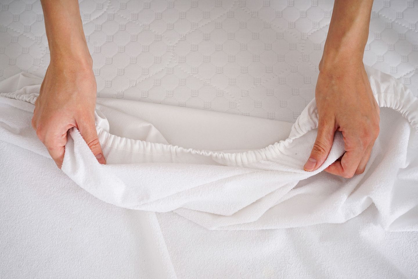 A person holding clean white sheets