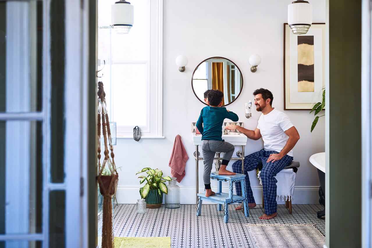 father with a kid brushing teeth