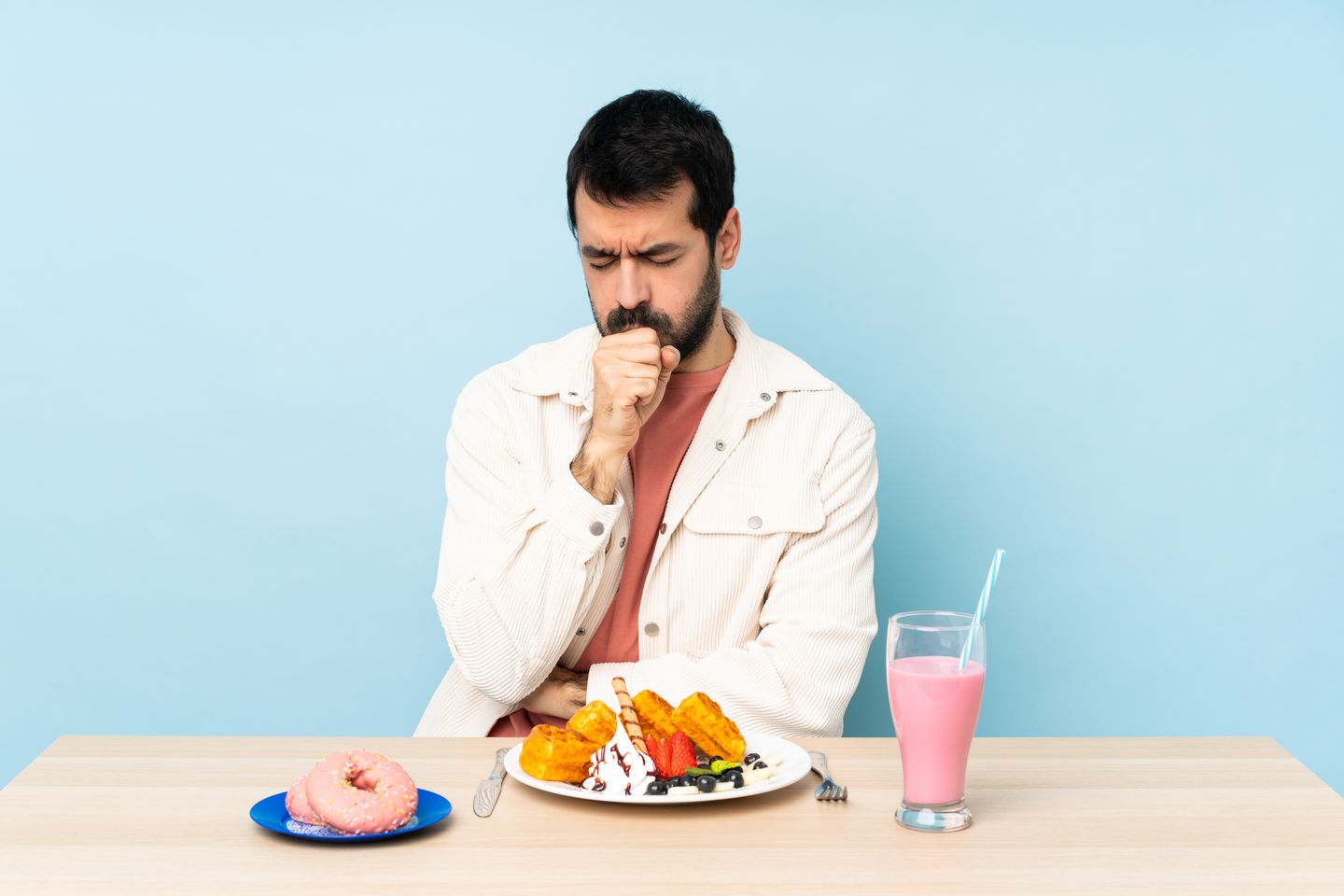 Man coughing while eating food