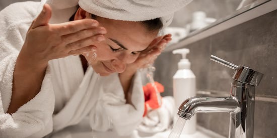 Woman washing off face wash	