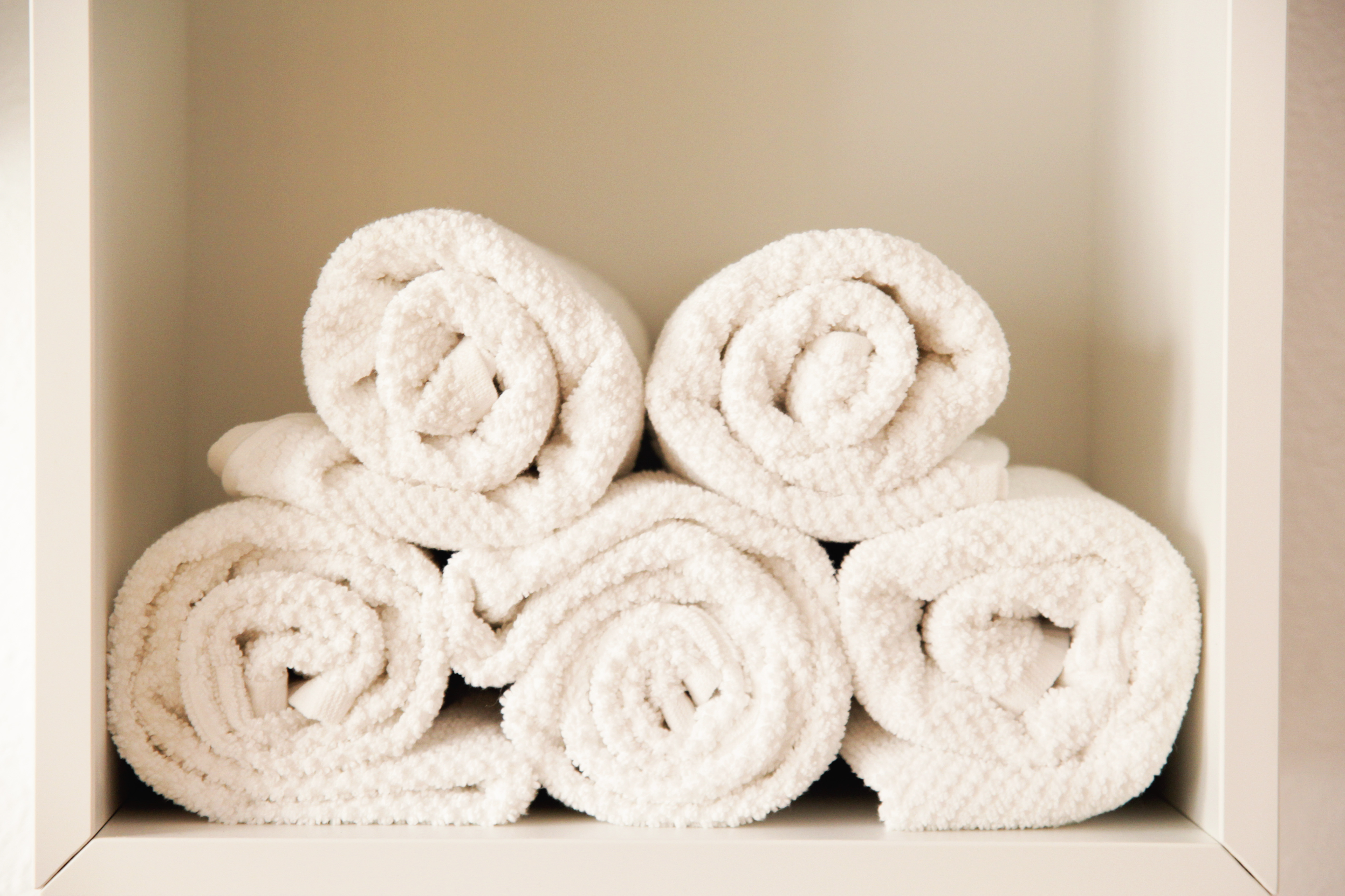 Rolled-up towels stacked in a shelf