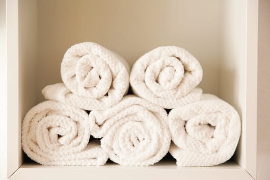 Rolled-up towels stacked in a shelf