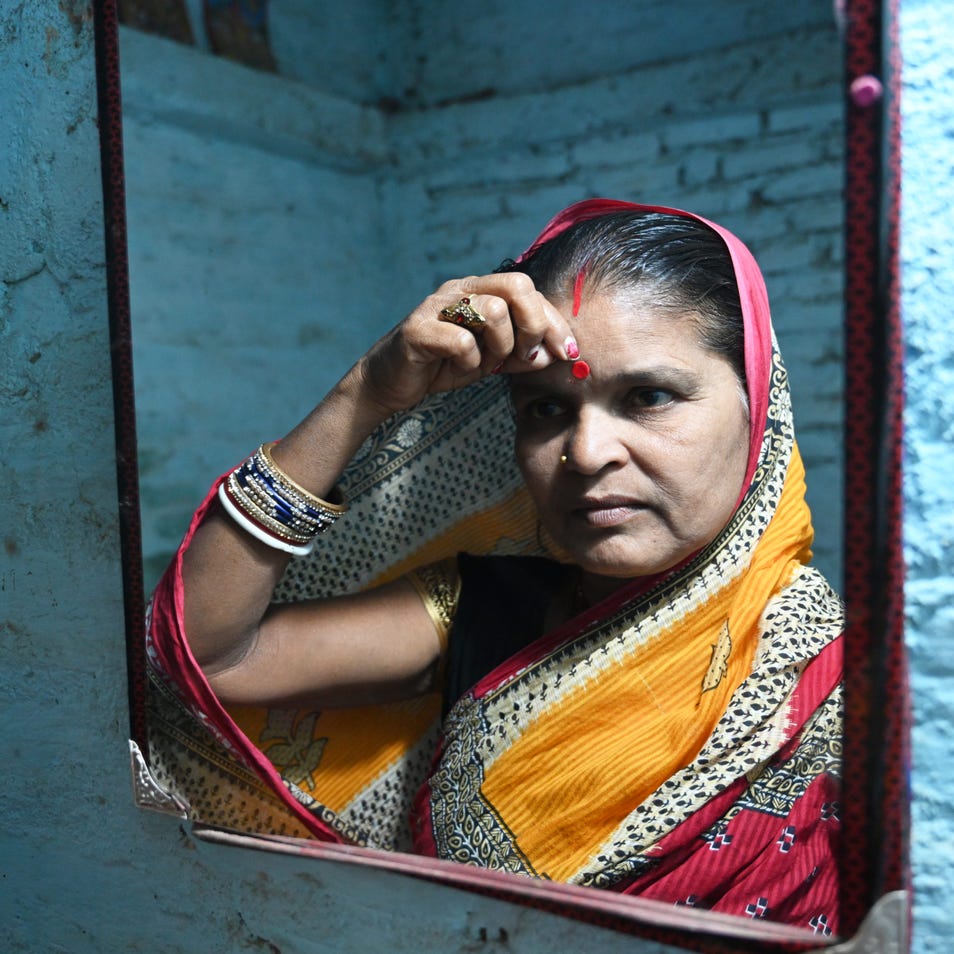 Indian Woman standing in front of the mirror 
