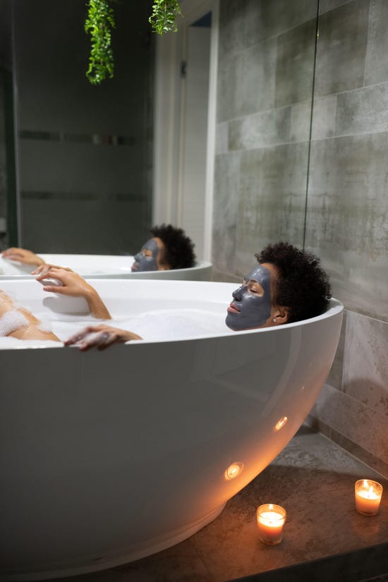 woman in face mask relaxing in a bath