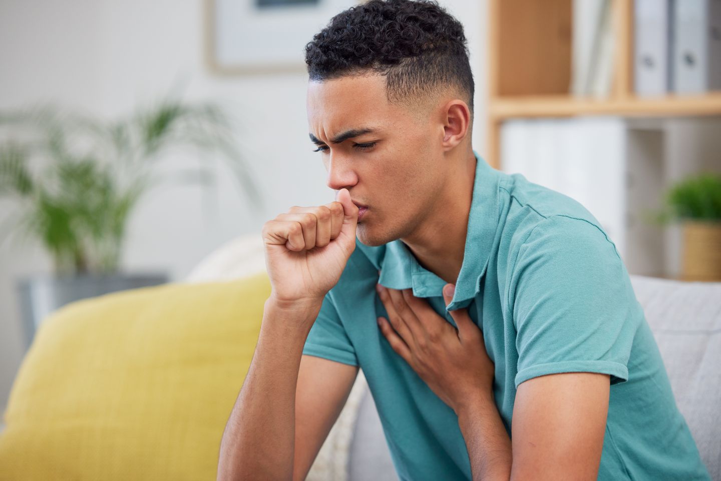 Person coughing into his hand