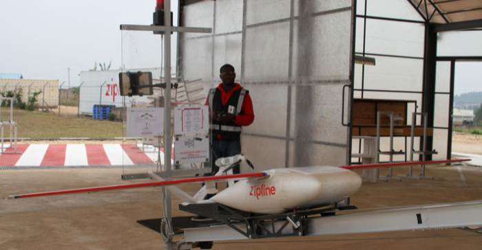 In this photograph, An employee of the Silicon Valley company Zipline is preparing a drone that will fly life-saving blood supplies to a remote clinic in East African Rwanda.