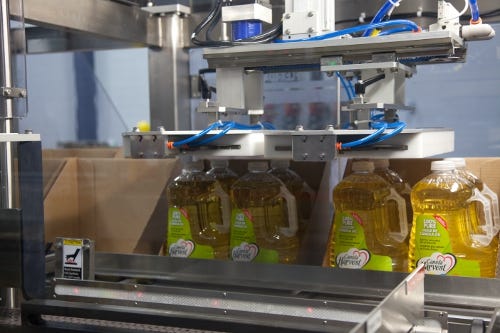 299472-Four_3L_jugs_of_Canola_Harvest_100_Pure_Canola_Oil_are_queued_up_and_then_loaded_into_retail_ready_trays_.jpg