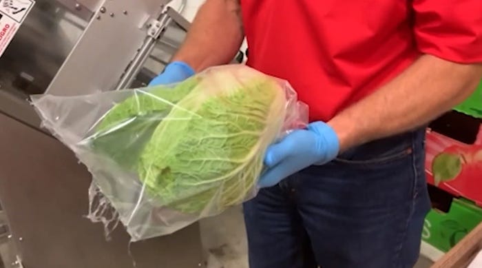 John Kreger holding a bag of produce at the MCFB Produce Rescue Center