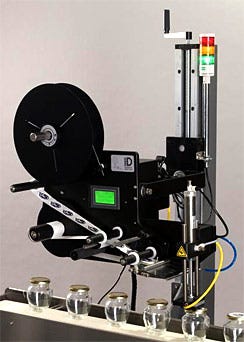 Label applicator with tamp module