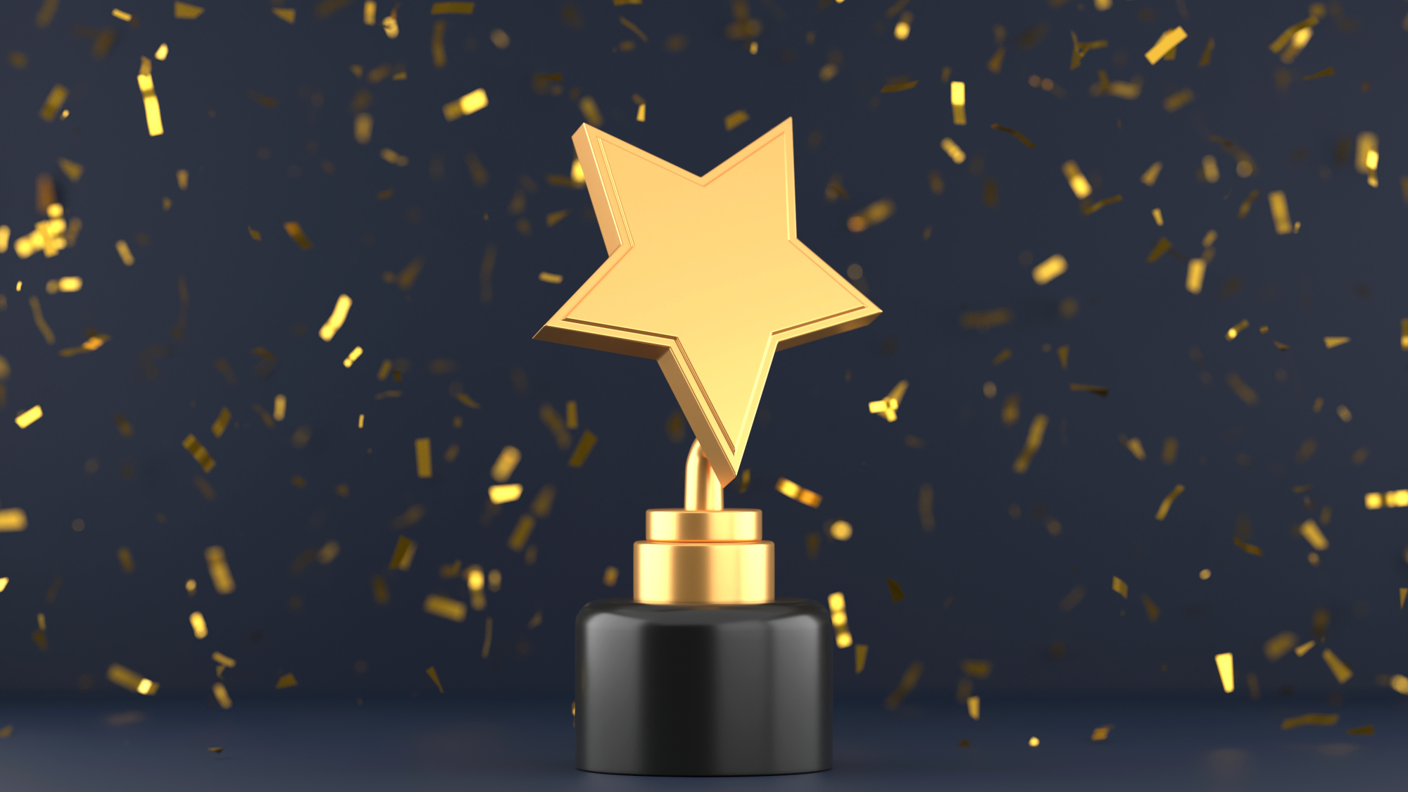 Gold star trophy on a table with gold confetti falling