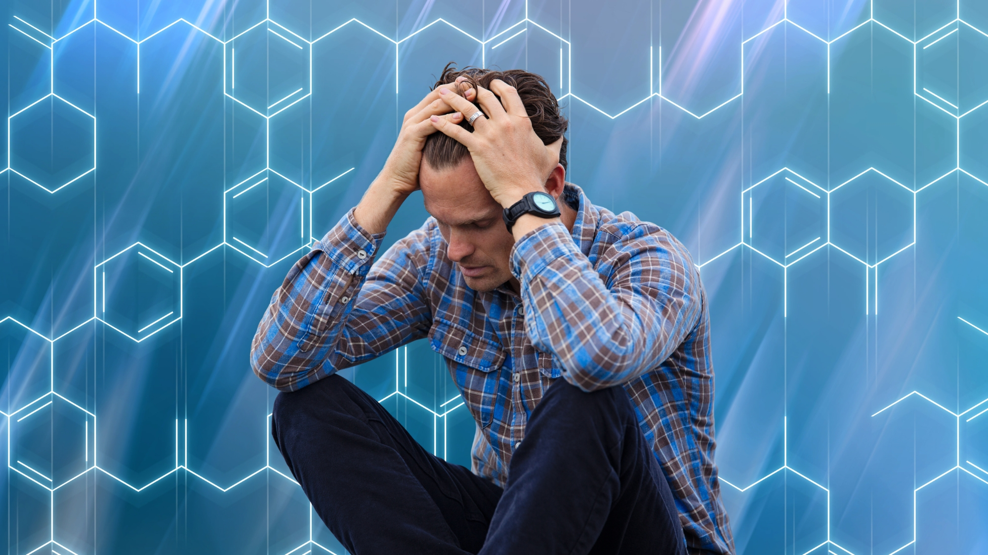 Man looking worried with hands on head on a background of polymer chains
