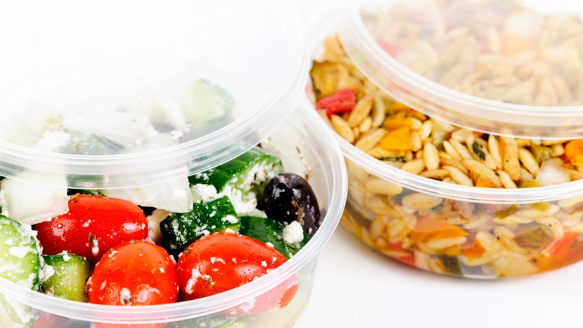 Salads in plastic takeout containers.