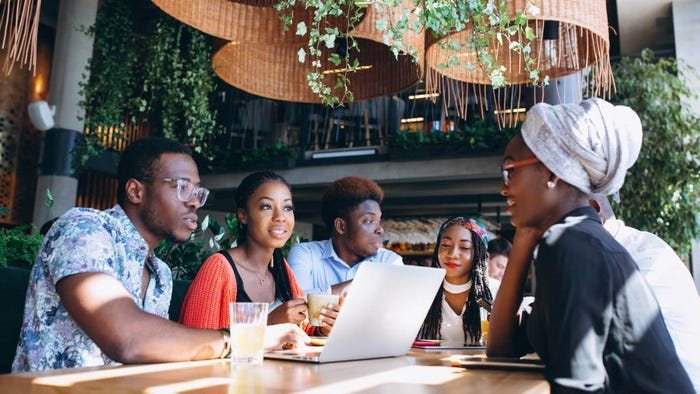 Group of young people looking at laptop.  Group of young people looking at laptop.