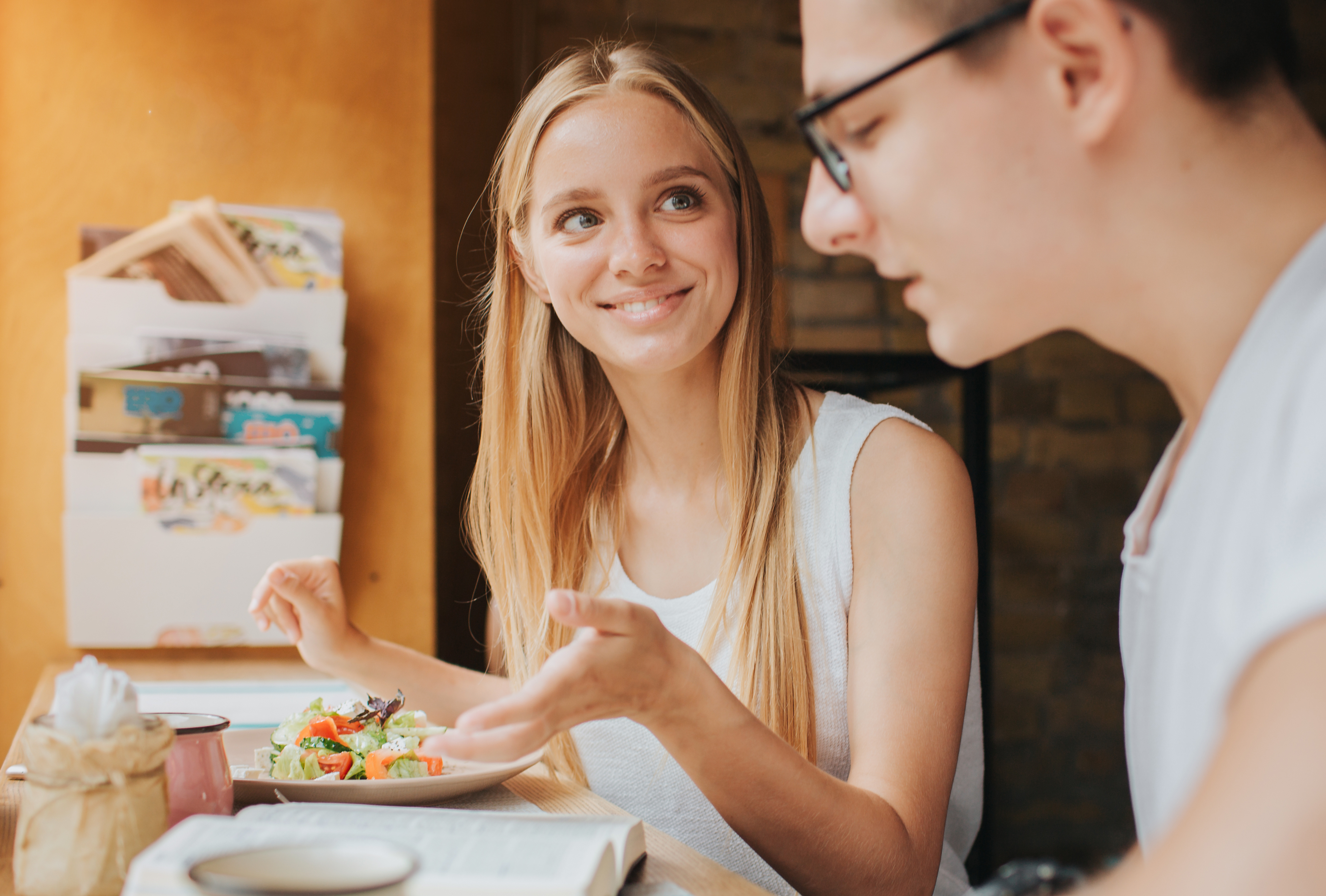 Two people talking and eating