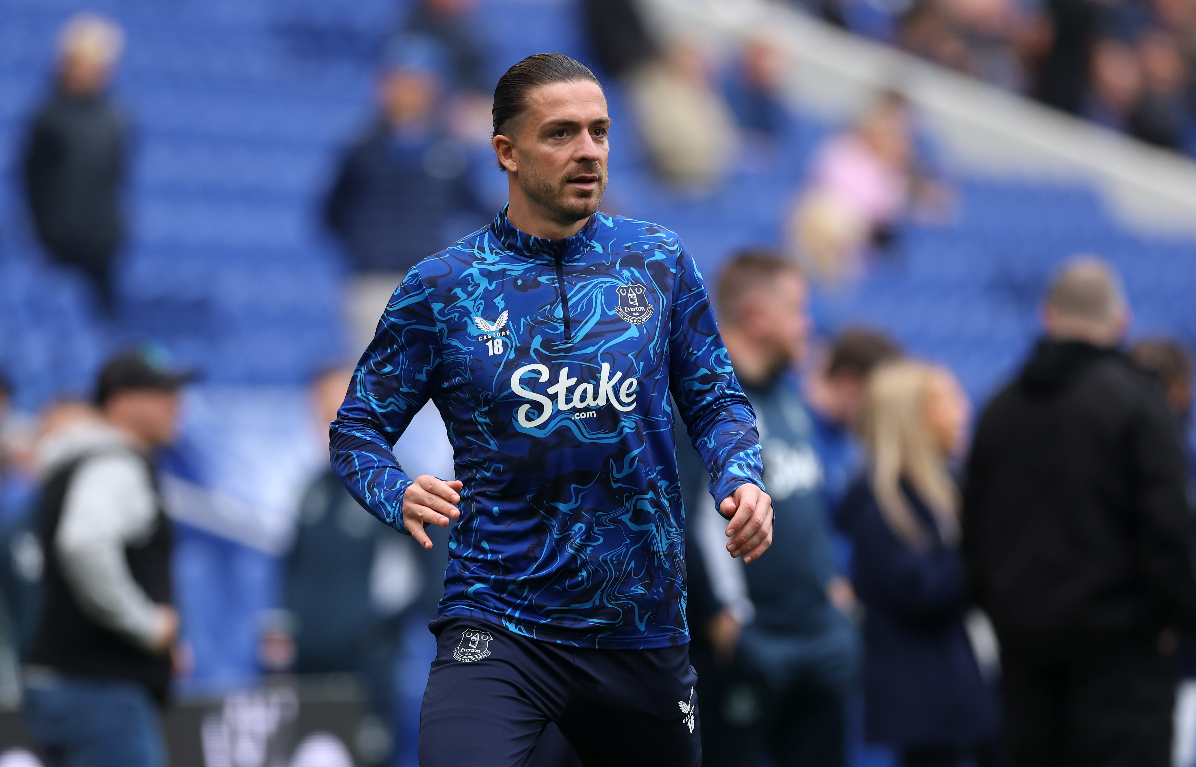 Jack Grealish in Everton training kit, focused during warm-up