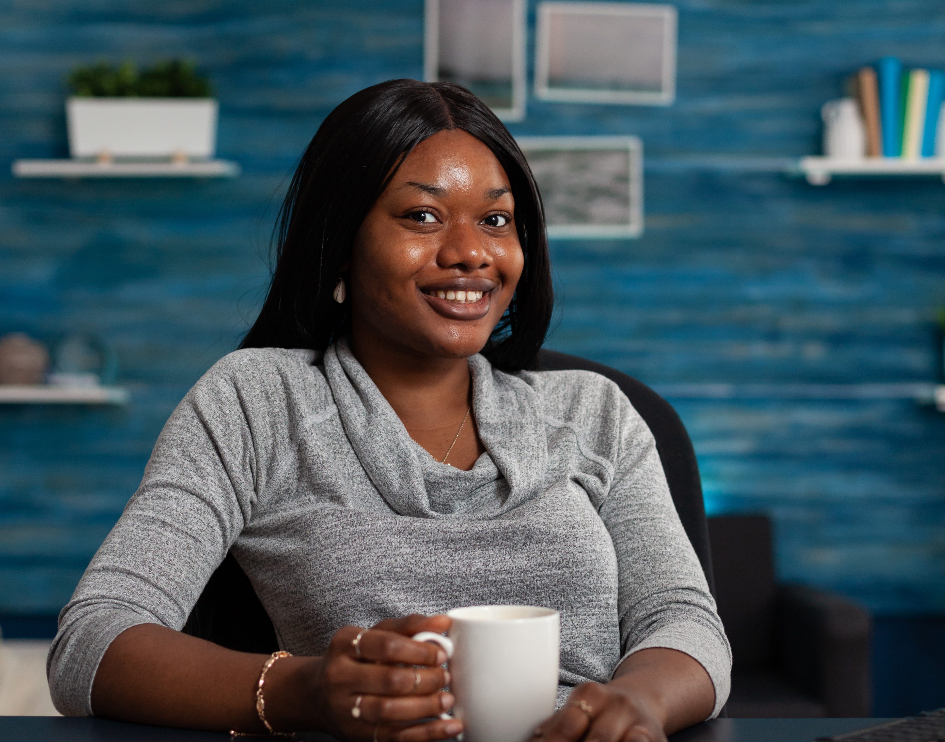 portrait-woman-smiling-sitting-desk-with-computer-working-from-home-business-project-young-adult-looking-camera-using-monitor-with-keyboard-remote-work.jpg