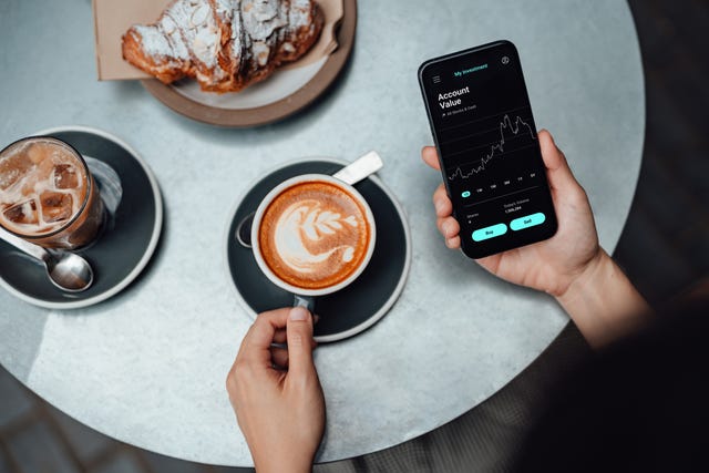 Man enjoying coffee while on his mobile phone