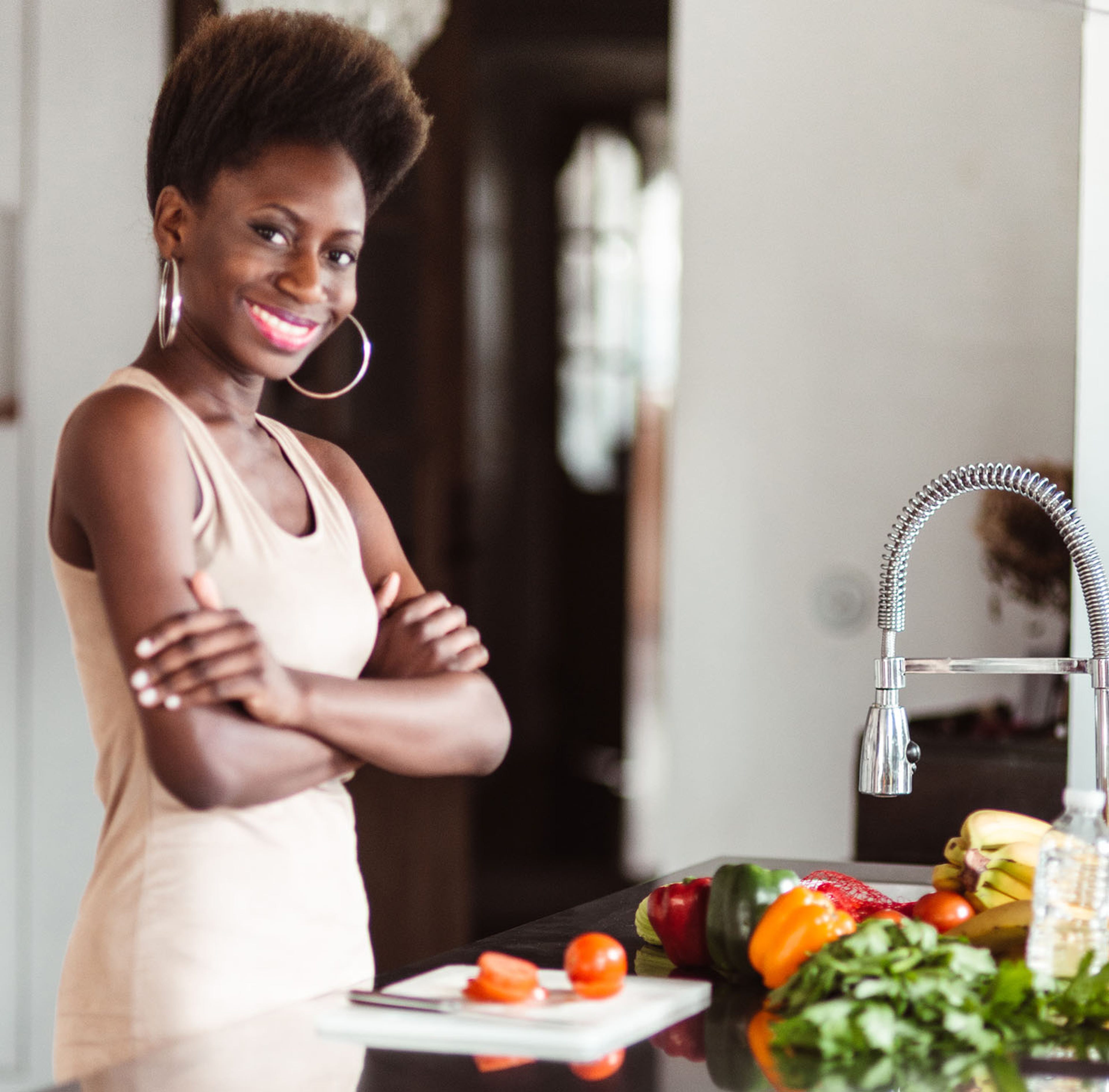 Lady with hands folded in the kitchen