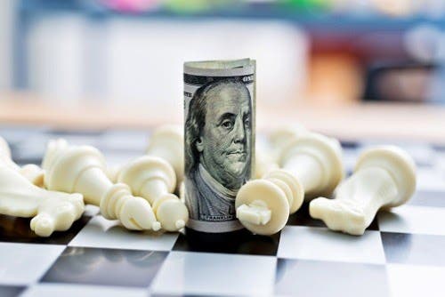 dollar-and-chess-pieces-picture-id957416038.jpg