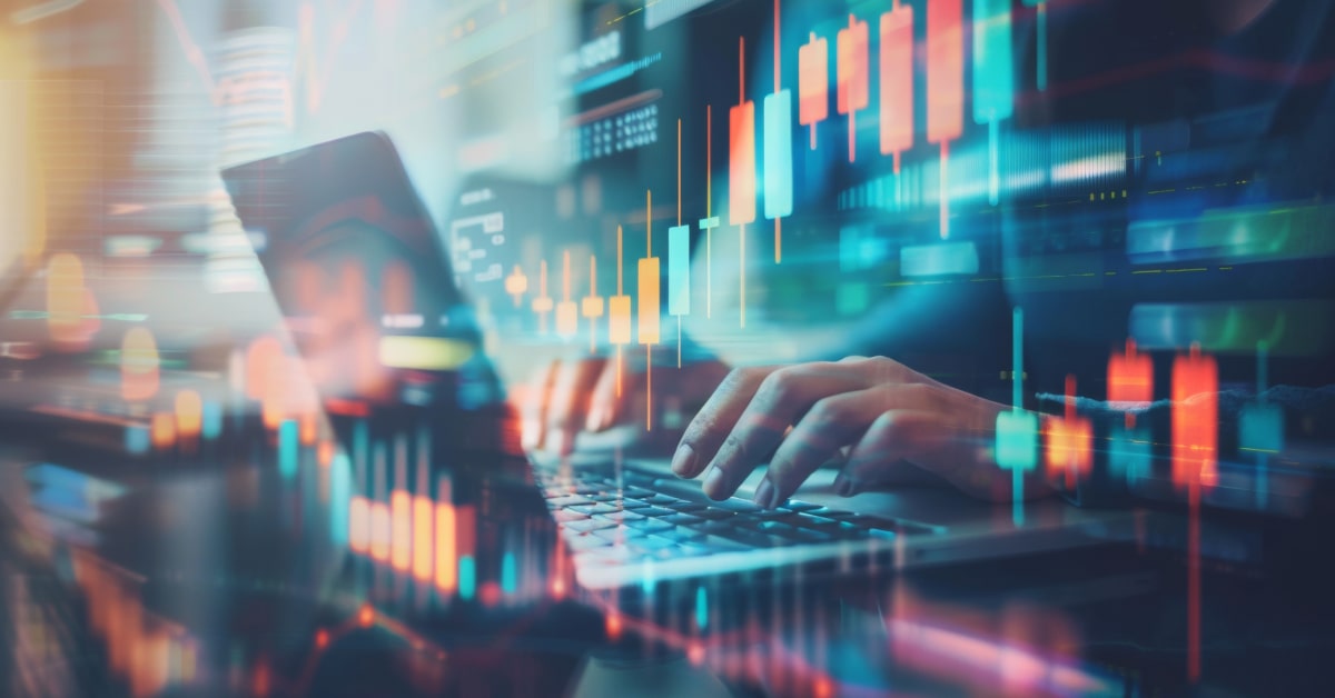 Hands working on laptop with trading overlay.jpg