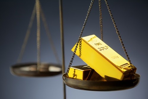 gold-ingots-on-brass-scale-picture-id500696290.jpg