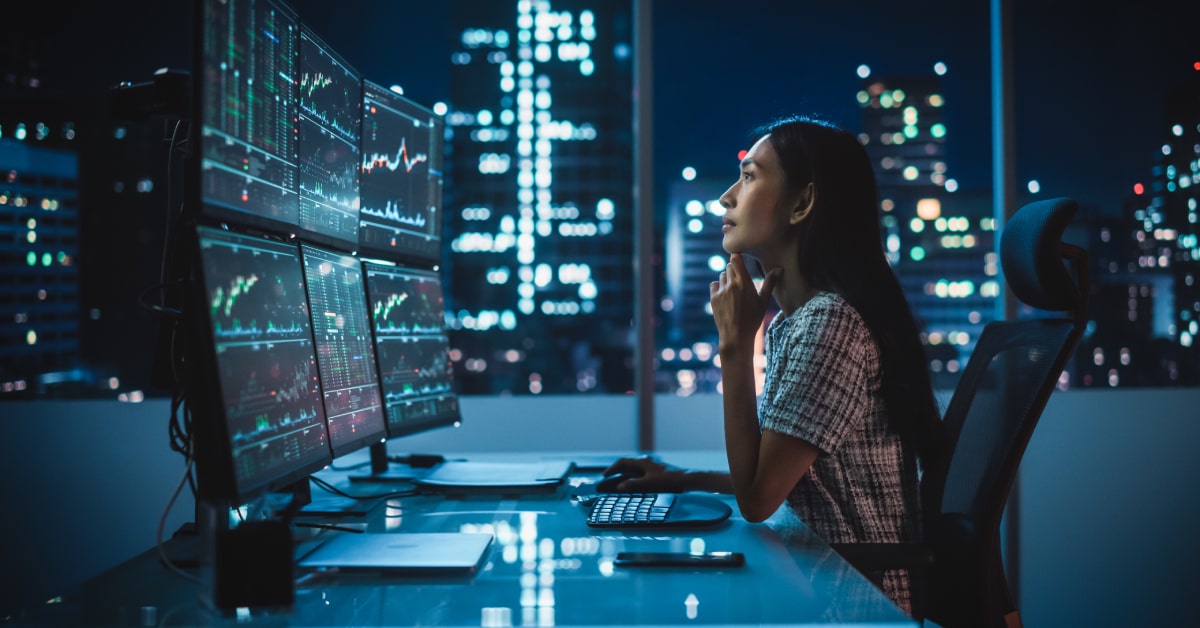 woman trading on multiple monitors.jpg