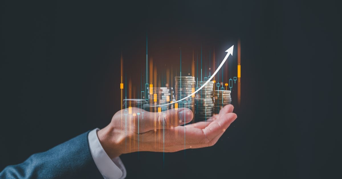 a businessman's hand holding an arrow with a city on it.jpeg