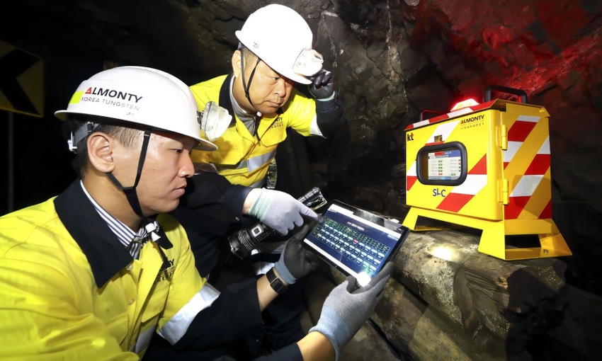 Workers at the Sangdong Mine in South Korea examine a newly installed Mine Safety DX system.