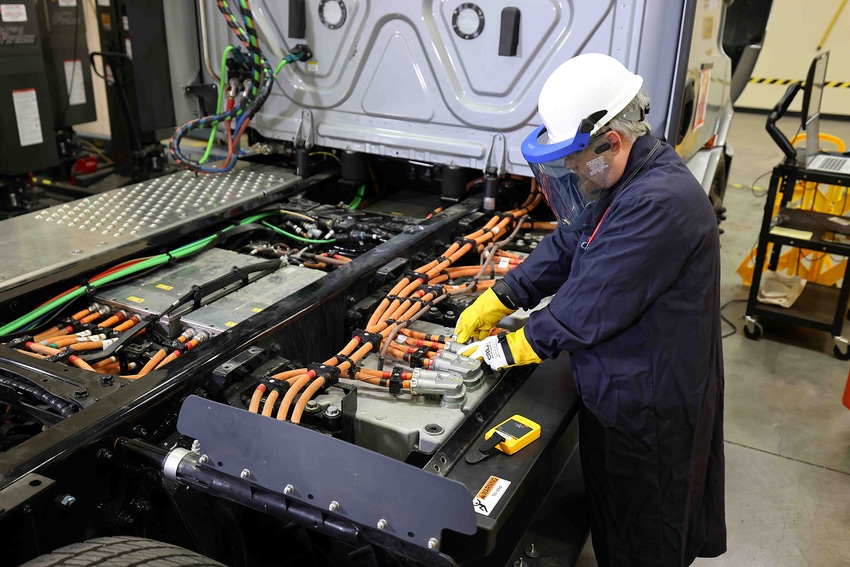 Technician examines a BEV truck power system