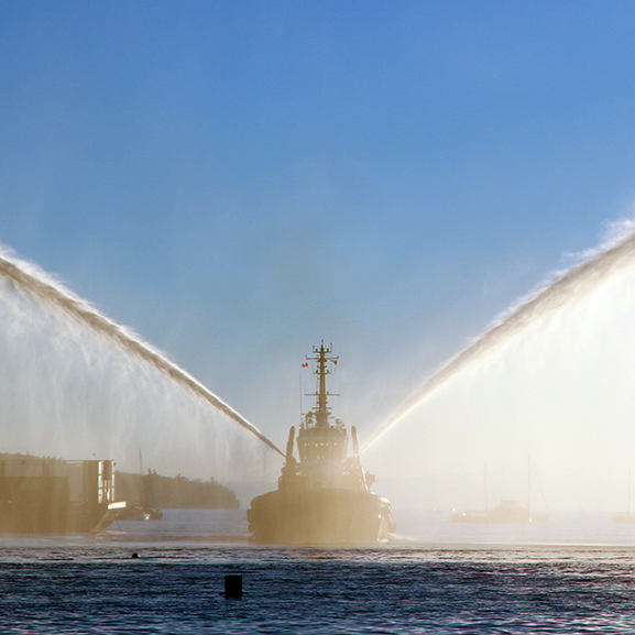 Why tug boats spray water into the air when towing ships 