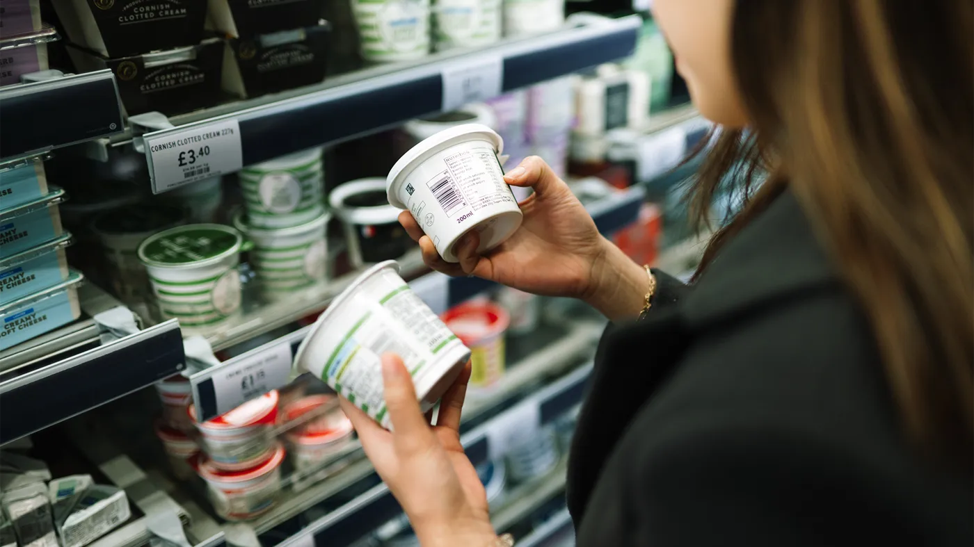Woman looking at labels at the supermarket Woman looking at labels at the supermarket