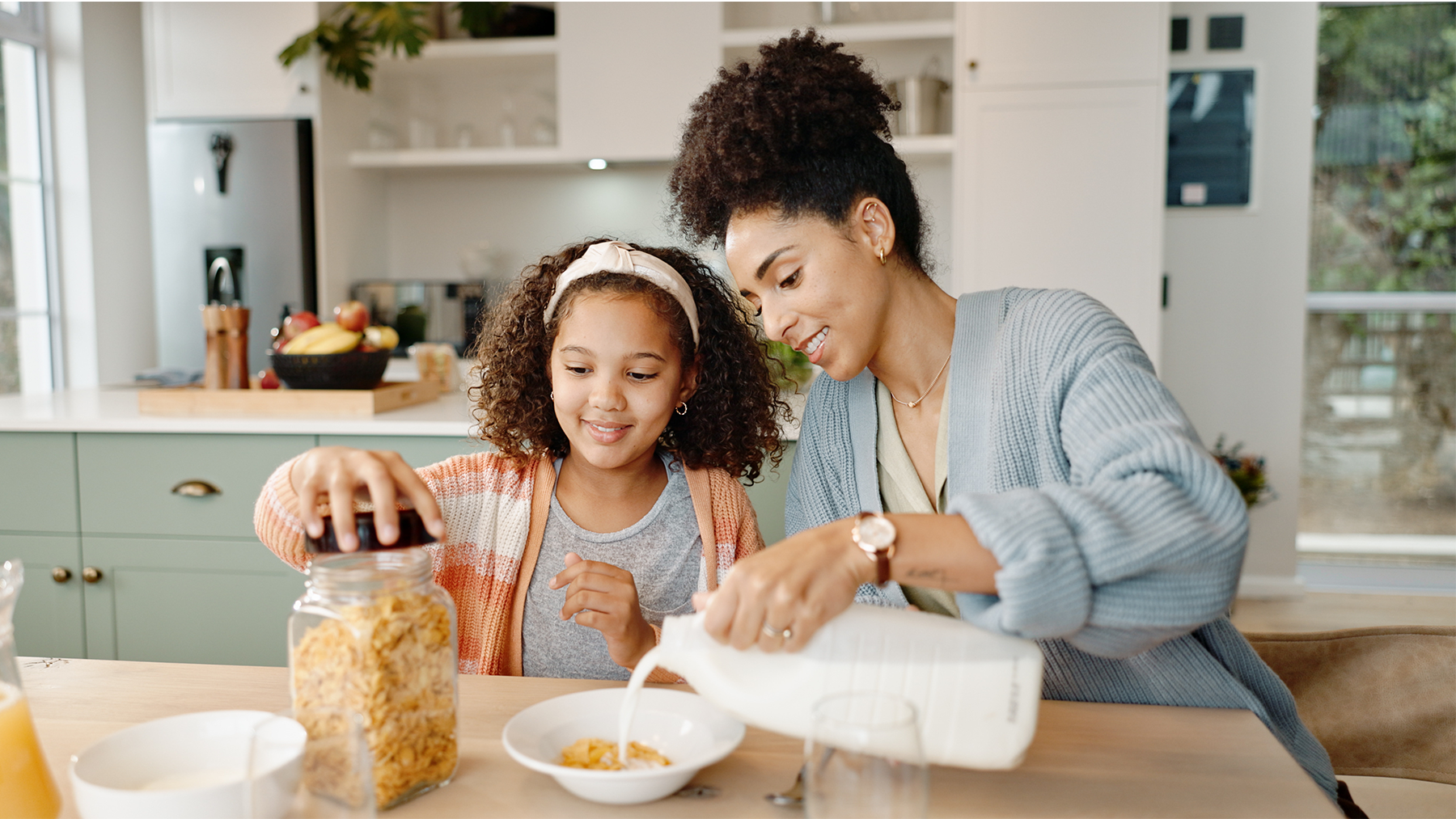 Mother, child and breakfast cereal in morning