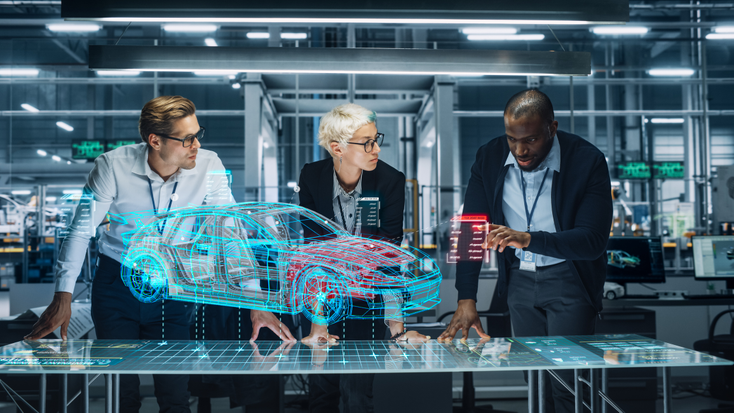 Three engineers examine a VR model of a car Three engineers examine a VR model of a car