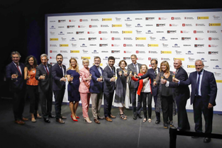 Members of GSMA on stage drinking sparkling wine at the opening of MWC 2023