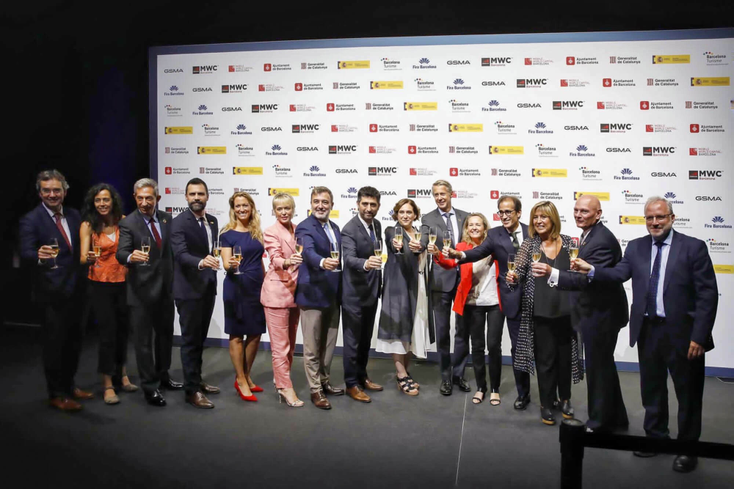 Members of GSMA on stage drinking sparkling wine at the opening of MWC 2023 Members of GSMA on stage drinking sparkling wine at the opening of MWC 2023