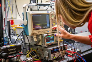 A researcher look at some lab equipment and displays