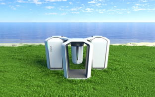 An IQM quantum computer in a field with sea in the background